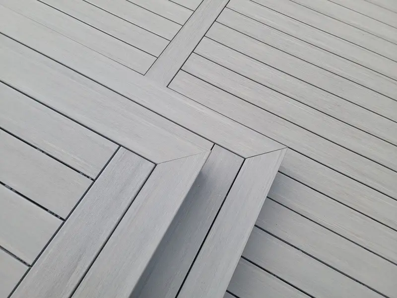 Gray composite deck boards with a mitered picture-frame border detail
