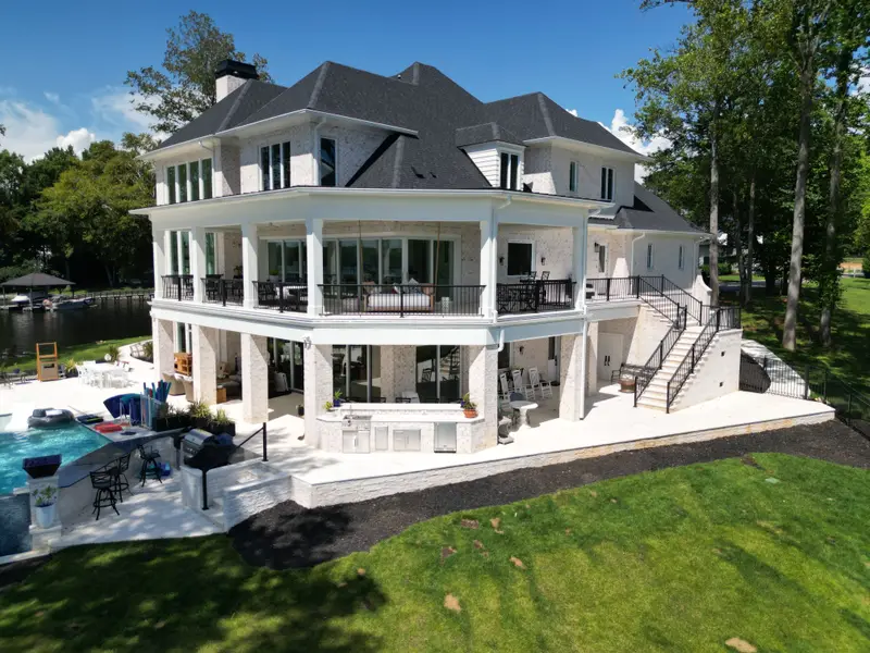 Lakefront home with multi-level covered porches, patio, and pool terrace on Lake Norman